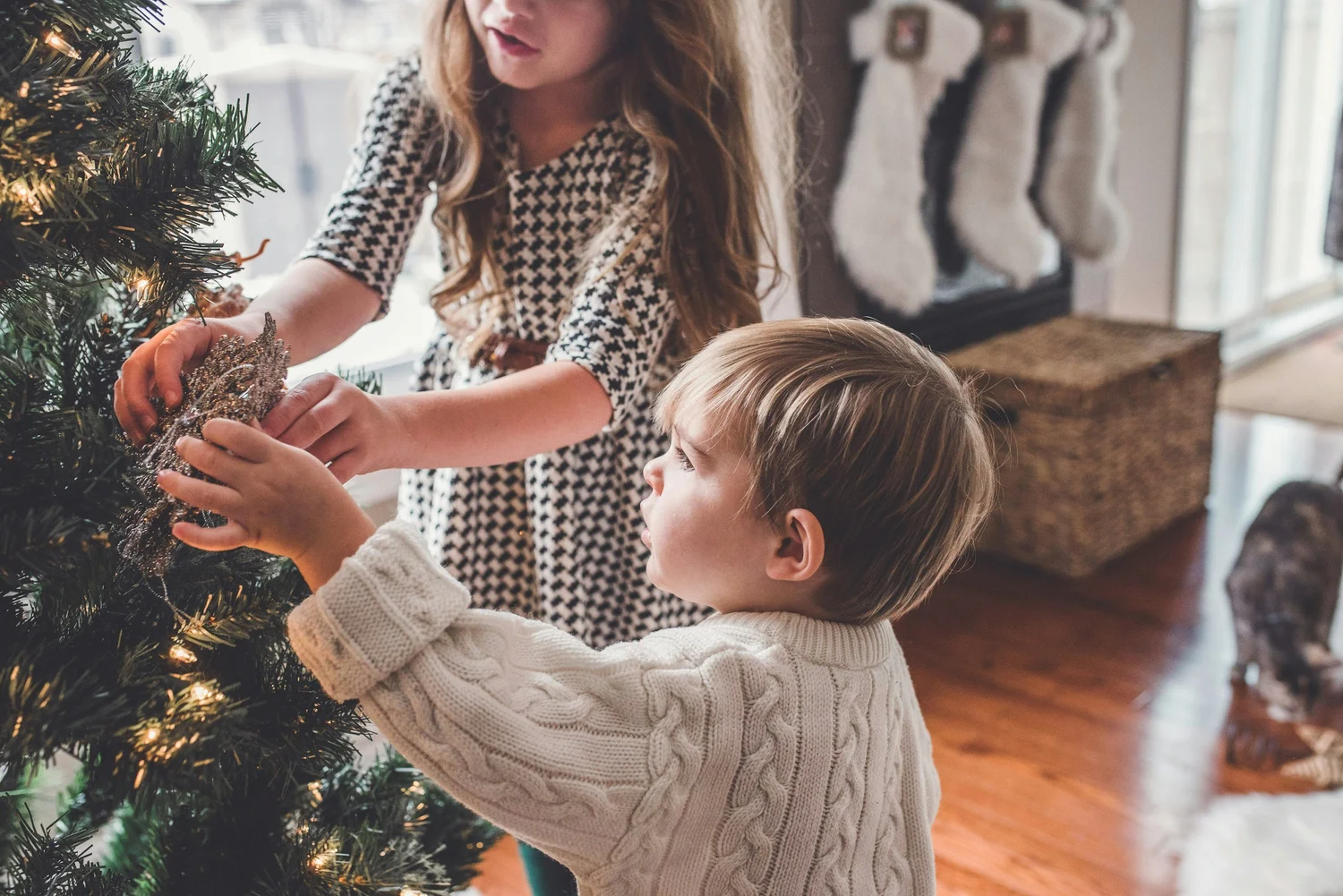A family decorating a Christmas tree together